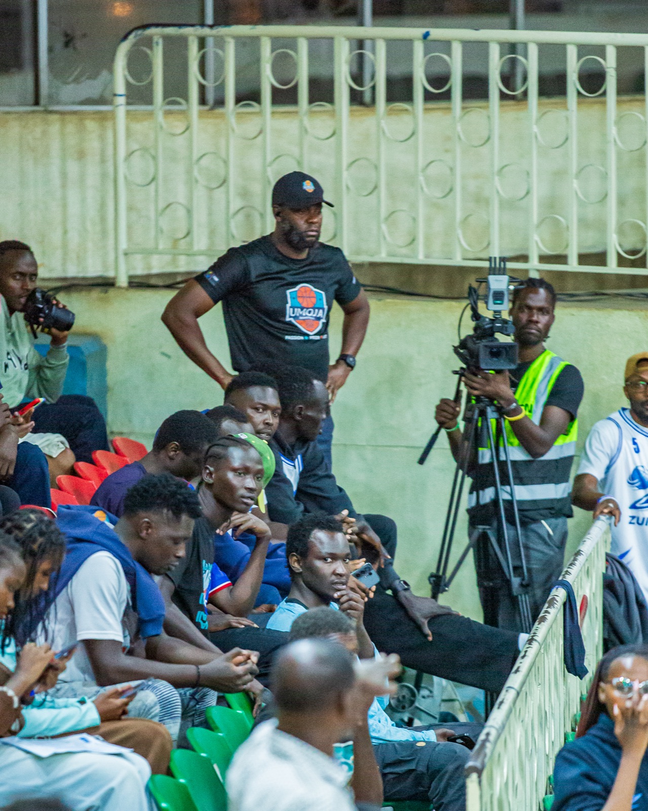Umoja bench and supporters watching the playoff game